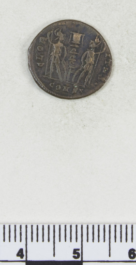 Hearst Museum object titled Coin: æ 4, accession number 8-6536, described as Coin: AE 4 Constans aug Ru. Standard between 2 soldiers