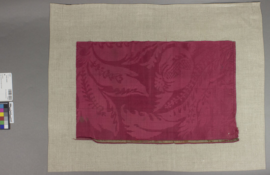 Hearst Museum object titled Textile sample, accession number 7-7617, described as Red silk strip with floral and foliage motives; damask; 10.75 by 17".