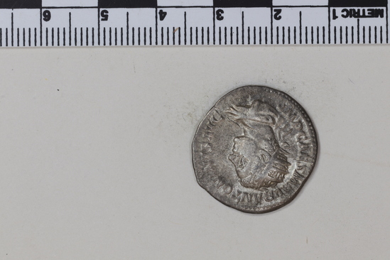 Hearst Museum object 2 of 8 titled Coin: billon denarius, accession number 8-4355, described as Coin; AR; Billon Antoninianus; Roman. 4.66 grams, 23 mm. Elagabalus, 218 AD. Rome, Italy. Obverse: IMP CAES M AVR ANTONINVS AVG, bust r. radiate. Reverse: P M TR P COS P P, Roma seated l.