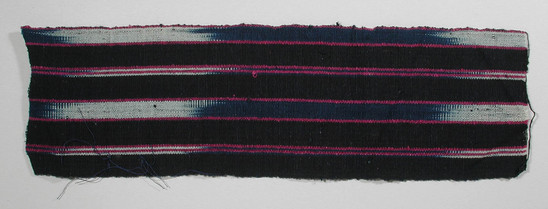 Hearst Museum object titled Textile fragment, accession number 5-11330, described as textile sample (section of narrow band weaving): four wide stripes, black; six sections ikat: indigo and white each flanked by magenta.