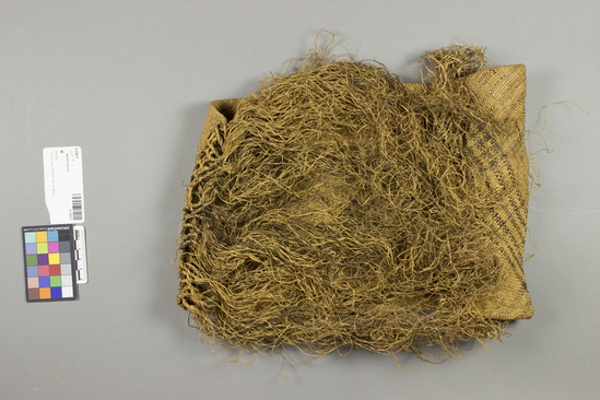 Hearst Museum object titled Basketry cap, accession number 5-13017, described as Basketry cap., Sierra Leone, Sherbro Mission, Sherbro attr. 1884. 5-13017, acc no. 3198. File code: 3.1 Orig. No. 2. Collector: Rev. E.C. Lemmon through Rev. R. West. Donor: Mrs. Jane Erickson. Materials, techniques: Raffia matting in plainweave; macrame in raffia Context of use: Said to be chief's hat. Description: Cap of fine plainweave raffia matting; folded over and self-fringed at base; open at top which ends with macrame and raffia fringe; diagonal black bands on straw-colored ground; l. not incl. fringe at top 40 cm.