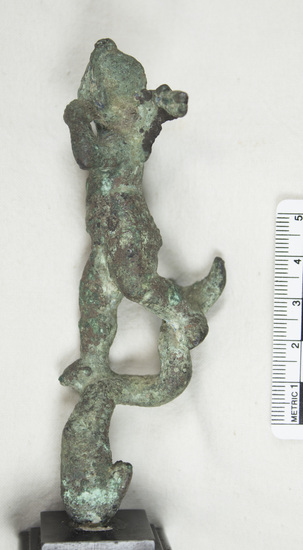 Hearst Museum object 2 of 12 titled Cupid figurine, accession number 8-4598, described as Small bronze winged figure on dolphin; right forearm missing