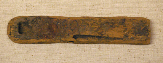 Hearst Museum object 1 of 9 titled Scribe's palette, accession number 6-14965, described as Scribe’s palette. Wooden slab; 2 depressions ( for red and black paint) and groove on 1 side (to hold a pen). length 16 cm.