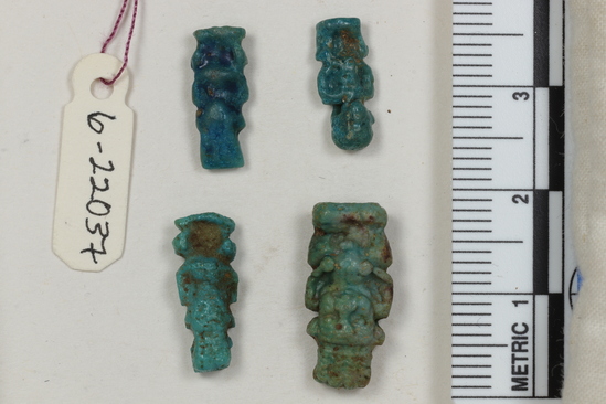 Hearst Museum object 15 of 22 titled Amulets, accession number 6-22037, described as amulets, of blue faience, and one pyramidal seal of steatite