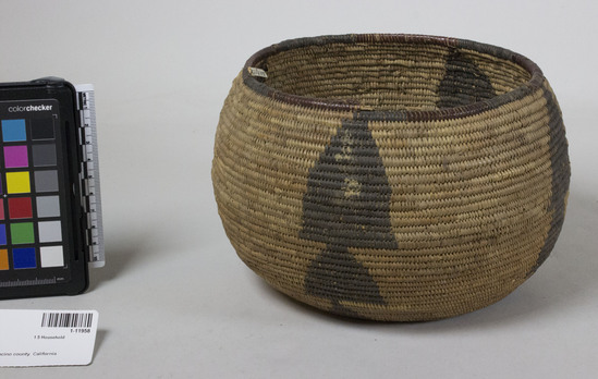 Hearst Museum object 2 of 2 titled Storage basket, accession number 1-11958, described as Small globosely coiled basket.  Tag "Yuki". Per Ralph Shanks:  Coiled globular basket bowl, probably made for storage.  Some residue in the interior.  The basket has a sewn over pinhole start.  The coil foundation is three rods of peeled shoots.  The background wefts are peeled redbud background on the base but on the sides of the basket it is sedge root with dyed bulrush root designs.  The design is four vertical bands of three upward- pointing stacked triangles.  There are random rectangles on the base, as well as some incorporated into the bulrush triangles.  The rim is plain wrapped with about every two inches of unpeeled redbud alternating with bulrush; the rim coil ending has six up to the right diagonal backstitches with two stitches covering the backstitches that are down to the right.  The weft fag ends are primarily clipped, with some concealed.  The weft moving ends are primarily concealed.  The basket has non-interlocking stitches.  The wefts on the exterior are less than 5% split; the wefts on the interior have over 40% split.  The basket has an exterior workface, with a rightward work direction, and a down to the right slant of weft twist.  Susan Rubin is said to be Yuki on the 1900 US census.  The note on this basket by Barrett's informant says that Yuki did not "use roots".   It is possible that Susan Rubin may have been Huchnom, who are known to use sedge root and bulrush root.  Huchnom used to be called Yuki as well.