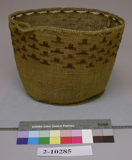 Hearst Museum object titled Basket, accession number 2-10285, described as Twined with upper edge having braided loops for drawstring; made of grass stems; decorated with worsted of various colors. Broken.