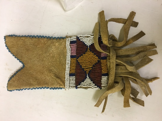 Hearst Museum object titled Pouch, accession number 2-5477, described as Buckskin; fringed; beaded geometric designs in red, tan, white, pink, and blue.