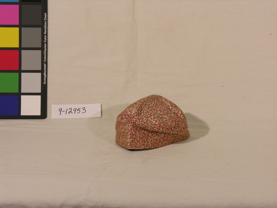 Hearst Museum object titled Cap, accession number 9-12953, described as Cap; red and white brocade, birds and trees; brown cotton lining, *child’s praying cap; materials/techniques: Lanchoi brocade, cotton lining.