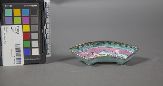 Hearst Museum object 12 of 13 titled Box, accession number 9-17802a-g, described as box (sweetmeat); wood, black lacquer exterior, painted gold birds and flowers on lid; body with painted floral sprigs; painted gold interior; lid and box with scholar and aide in black; five enamelled metal insert trays, each with one of the five Immortals in landscape scene. “Nade Inohina” (Made in China) stamped on bottom of each tray; early 20th century