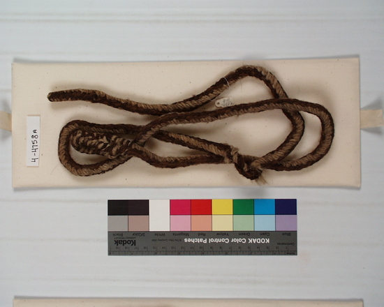 Hearst Museum object titled Bag w/ salt: rags: cords, accession number 4-4758, described as Town cotton bag with 2 lumps of rock salt and some rags. (a-c) braided woolen cords, (a) provided with loop