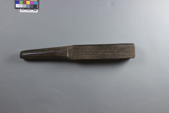 Hearst Museum object 3 of 6 titled Tapa beater, accession number 11-40681, described as Quadrangular blade has 2 sides with deep longitudinal grooves, one pitted side, one side with shallow longitudinal grooves with some incised dots; rounded handle. Made of carved hardwood.