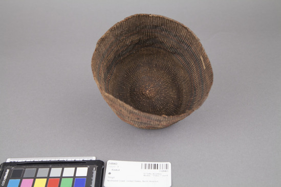 Hearst Museum object 2 of 3 titled Basket, accession number 2-68463, described as Round with concave bottom, straight sides, 2 bands of geometric false embroidery, colors faded, badly stained throughout, edge broken in several areas. Spruce root, grass stems, dyed, plain twined.