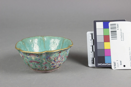Hearst Museum object titled Bowl, accession number 9-16447, described as Bowl; ceramic bowl with short foot and flared hexagonal flattened scallop rim, worn turquoise interior, exterior has turquoise ground with floral design framing 6 panels: alternatively, a bat with the Sacred Fungus and a flower (chrysanthemum ?), rust red seal on bottom, gilt rim. Height 4 cm., diameter 8.75 cm.