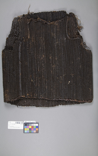 Hearst Museum object titled Armor vest, accession number 11-41139, described as “Armor” vest; rattan; coiled from edge to edge with heavy braided string arm’s eye. Length 46.5 cm, width 43 cm. Defensive clothing for warfare.