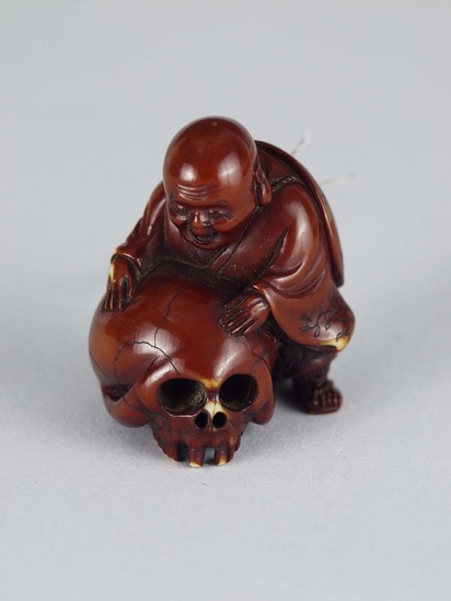 Hearst Museum object titled Netsuke, accession number 9-7599, described as Netsuke: bald smiling man standing with huge skull. Characters inscribed on skull. By Kosen. Height: 3.6 cm Notice: Image restricted due to its potentially sensitive nature. Contact Museum to request access.