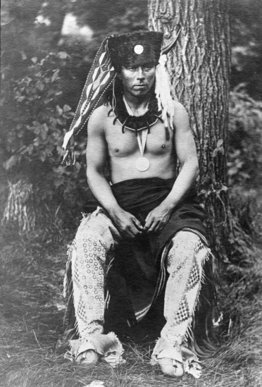 Hearst Museum object titled Photograph, accession number 13-91, described as Omaha man in traditional costume, otter skin cap, necklace, leggings, etc