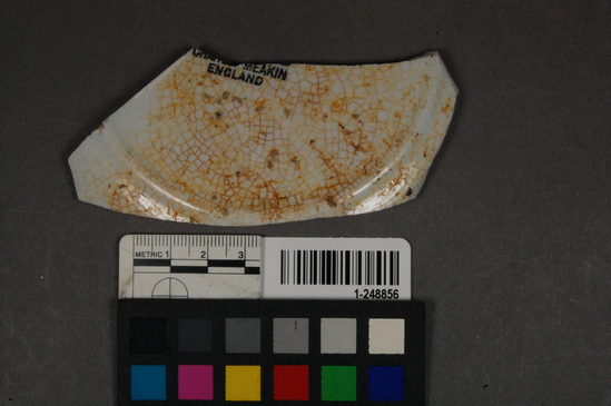 Hearst Museum object titled Ceramic fragment, accession number 1-248856, described as Ceramic bowl; base, fragment(s), refined white earthenware; maker’s mark glazed