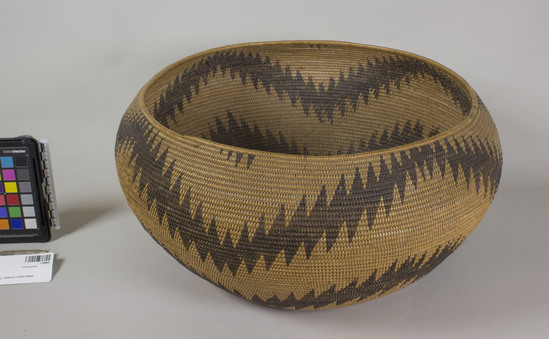 Hearst Museum object 2 of 2 titled Basket, accession number 1-28806, described as Coiled, 3 rod basket.  Zigzag encircling black and brown design, with points top and bottom.