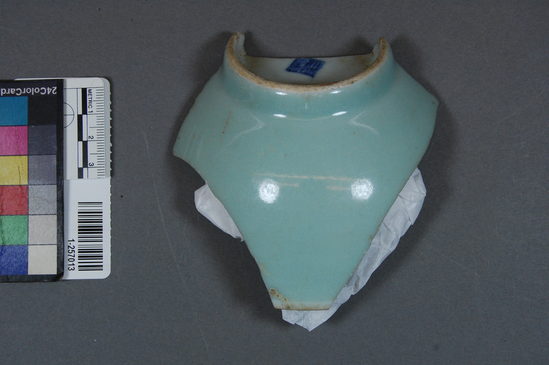 Hearst Museum object titled Ceramic bowl fragment, accession number 1-257013, described as Bowl base and body fragment, celadon, maker's mark, 10.3 centimeters