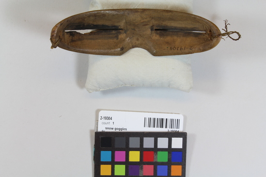 Hearst Museum object 2 of 2 titled Snow goggles, accession number 2-19304, described as Unstained wood, framentary sinew tie.