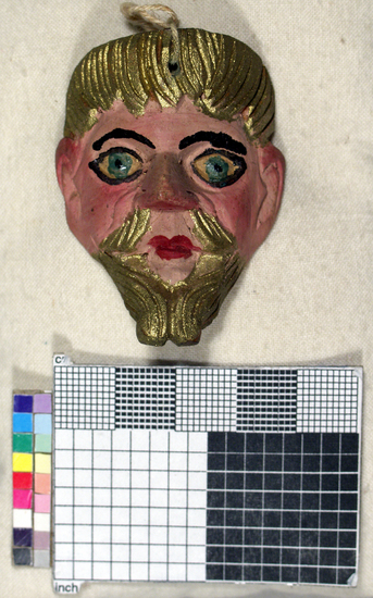 Hearst Museum object titled Toy mask, accession number 3-15586, described as Carved wooden toy mask; painted pink face