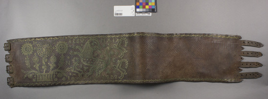 Hearst Museum object titled Belt, accession number 7-217, described as Broad heavy leather belt, ornamented with brass studs worked into forms of lions, goats, deer, etc. Date in brass studs "1808". 38'' long, 7'' wide. 4-buckle closure.