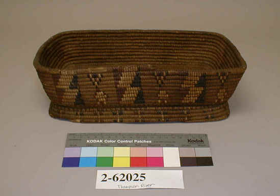 Hearst Museum object titled Basket, accession number 2-62025, described as Rectangular, coiled and imbricated. Geometric designs in black, red, and straw-colored material on exterior.  Foundation and sewing strands of red cedar bark, imbrication in Xerophyllum tenax and wild cherry bark (partly dyed black). Poor condition. Note: appears to be unifinished.