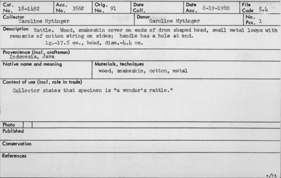 Documentation associated with Hearst Museum object titled Rattle, accession number 18-1492, described as Rattle. Wood, snakeskin cover on ends of drum shaped head, small metal loops with remnants of cotton string on sides; handle has a hole at end. length - 17.5 cm.; head, diam. - 4.4 cm. Collector states that specimen is "a vendor's rattle.