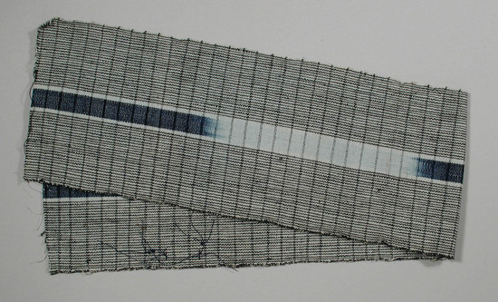 Hearst Museum object titled Textile fragment, accession number 5-11309, described as textile sample (section of narrow band weaving): light blue and white pin stripes both outside panels, central panel: ikat: indigo within light blue.