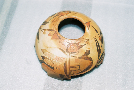 Hearst Museum object 4 of 7 titled Bowl, accession number 2-18708, described as Ceramic, terraced rim, round hole in base, geometric design on interior, stylized bird and floral design on exterior in brown and red on buff/orange ground. Molded and painted.