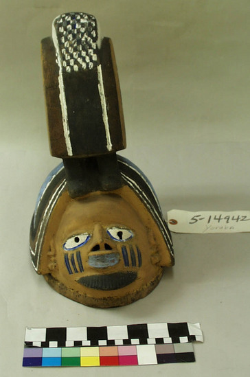 Hearst Museum object titled Mask, accession number 5-14942, described as Anthropomorphic, Gelede mask ( from Save? (2500) 1944) ; Representing Egungun; One of a pair (see #47).Yellow ground with white, purple and black. H = 38.0cm