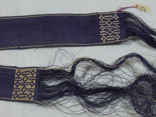 Hearst Museum object 2 of 3 titled Belt, accession number 11-208, described as Belt or ribbon of fiber, violet.