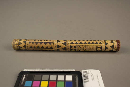 Hearst Museum object 2 of 2 titled Lime container, accession number 10-2219, described as Bamboo lime container; incised geometric designs and fish, band of plaited rattan around each end; 10¼ inches long.