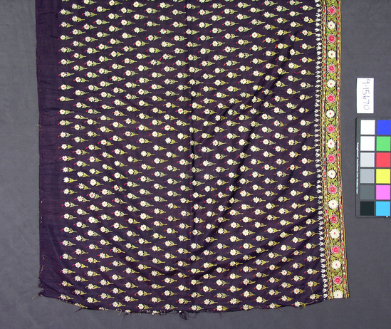 Hearst Museum object titled Skirt, accession number 9-15670, described as Skirt, "ghagra".  Silk.  Plain weave, embrodered.  Purple ground, varicolored designs.  Ground may be fade black.  Yellow binding.  Flower motive (Phulkari).  2 yards, 22½ inches by 1 yard.