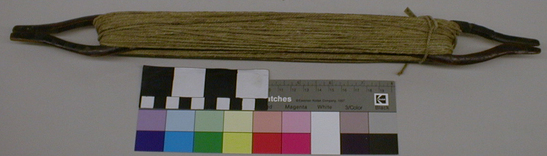 Hearst Museum object titled Shuttle, accession number 1-9486, described as Netting shuttle, wood, handcarved with oval opening and slot at each end.  One "tong" broken and indigenously repaired with fiber; with string of two stranded vegetable fiber.