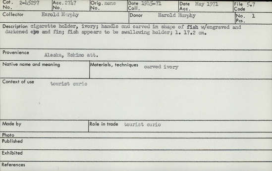Documentation associated with Hearst Museum object titled Cigarette holder, accession number 2-45297, described as Made of ivory.  Handle end carved in shape of fish with engraved and darkened eye and fin.  Fish apears to be swallowing holder.