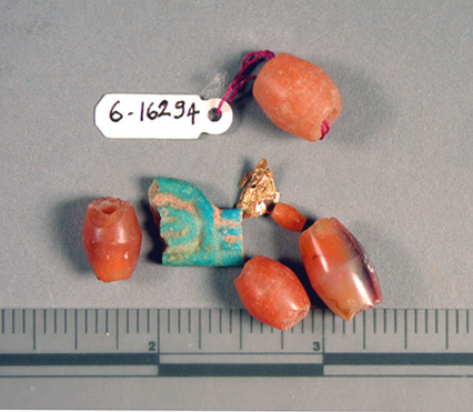 Hearst Museum object titled Beads, accession number 6-16294, described as Beads and amulet fragments: 5 carnelian barrel-shaped, 1 blue glaze fragment, 2 gold flakes