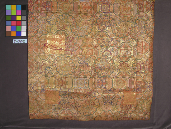 Hearst Museum object titled Robe, accession number 9-13556, described as Description: Mantle.  Large rectangle, made of 13 patched panels and a wide border.  Orange silk ground brocaded in green, blue, white, purple and gold, with geometric, floral, and dragon designs.  4 corner patches and 2 shoulder patches of different fabric - orange with brocaded gold floral pattern.  Purple lining, also pieced, shows some deterioration and staining.  One decorative knot with two hanging cords is attached to the left shoulder patch.  Context of use:  A typed white silk label sewn on lining reads: “Old red Nishiki brocade Kesa used for robe of Buddhist temple priest.  The brocade and the pattern are highly known as ‘Shokko Nishiki’.  This was woven by the famous Nishyin loom, Kyoto, about 125 years ago.  It is a fine example of a rare antique Japanese brocade.”  Another label reads “Clayes, San Francisco” with a price tag of $400.  The mantle dates from the late 18th century.  The cloth may have been woven for use by Chinese Buddhists, since the brocade pattern is derived from Tang designs of 700 AD.  The patched garment is symbolic of the poverty of Buddha.  A greater number of panels (such as this Kesa has) signifies higher rank.  The purple lining also shows high rank.  The corner patches, or Shi-Tenno, represent the 4 Kings of Heaven and the 4 compass points.  The 2 shoulder patches, or Bosatsu, are the 2 disciples of Buddha, Fugen and Monju.  The priest in his Kesa represents Buddha and his 2 assistants.  The mantle is worn over the left shoulder and under the right arm, and is tied in front.