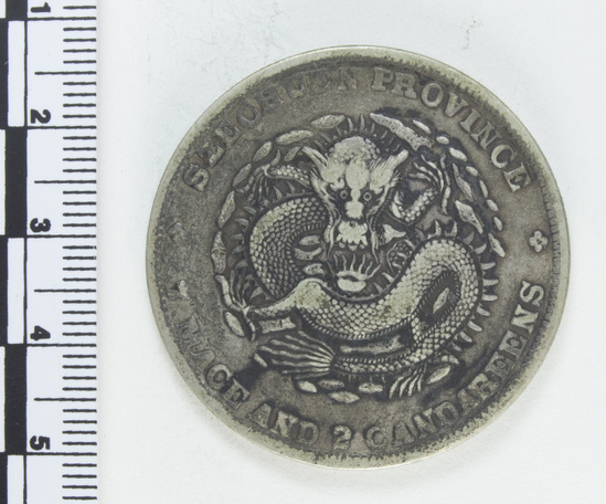 Hearst Museum object titled Coin: guang xu yuan bao, accession number 9-6017, described as Coin; Ag; 1 dollar; (7 mace and 2 candareens). Obverse: Dragon. Reverse: Chinese script; 1909.