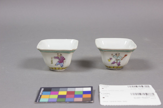 Hearst Museum object titled Cup, accession number 9-13430a,b, described as Cups, porcelain, with overglaze enamel decoration,  Square with corners, flared out sides, short foot. (inverted bell shape).  Child depicted on each side: one holding fish, others playing with unidentified objects.  Various colors on white ground.  Turquoise diamond pattern band near rim; Yellow and red stripe band at foot.  Interior plain.  "China" stamped on bottom.  H. (a) 6cm max.  Dia. 8.3 cm; (b) H. 4.7 cm, Dia. 8.2 cm Mold formed porcelain, with overglaze enamel decoration. Souvenir ?; novelty: The 'playing' children motif (wa wa) is a very popular theme on Chinese ceramics.
