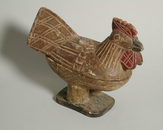 Hearst Museum object titled Bowl and cover, accession number 5-16758a,b, described as carved and painted wooden chicken. bowl (a) forms lower body and legs attached to rectangular base. cover (B) forms upper body, head and tail. body curved in geometric designs and parallel lines. beak feet and base black, wattle and comb red, body white (now very dirty).  Conservation: Wear and abrasion, very dirty.