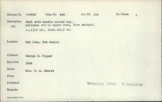 Documentation associated with Hearst Museum object titled Bowl, accession number 2-8559, described as Bowl with handle across top, polished red in upper area, fire smudged. Height 15.0 cm., diameter 14.2 cm.