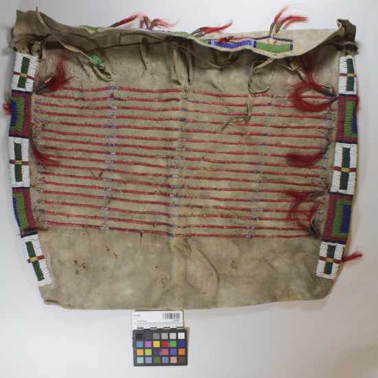 Hearst Museum object titled Saddlebag, accession number 2-41087, described as Woman's type, or wall pocket; decorated on one face with red and purple porcupine quills; multicolor beadwork and red-dyed horsehair in tin "tinklers" at side edges.