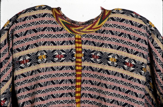 Hearst Museum object 2 of 3 titled Huipil, accession number 3-69, described as Woman’s shirt or "guipil"; white cotton; basket weave; also yellow and red; brocaded dark blue cotton; red and yellow silk embroidery; purple, red, green and yellow silk; embroidery around neck; approximately 1 m 19 cm wide 1 m 6 cm long; Red silk floss is cochineal (see letter in acc. env.)