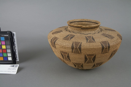 Hearst Museum object 2 of 2 titled Basket, accession number 1-234117, described as Money basket"; coiled.  Rectangles with brown and red designs on straw-colored ground.