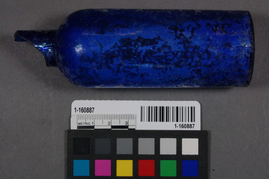 Hearst Museum object titled Bottle, accession number 1-160887, described as Mostly complete blue glass bottle, lacking the rim/lip finish. no embossing but mold seams present. No makers mark.