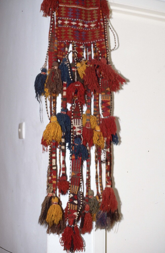 Hearst Museum object titled Color slide, accession number 25-25247, described as 35mm color slide transparency. Close-up of woven object with diamond patterns; featuring tassel detailing; colored red, orange, yellow, green, and blue.