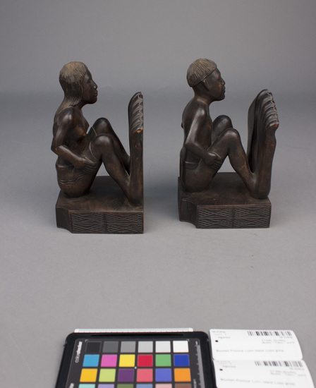 Hearst Museum object 6 of 8 titled Wood figurine, accession number 10-3141a,b, described as Bookends, wooden, male and female figures, 27 centimeters by 10 centimeters