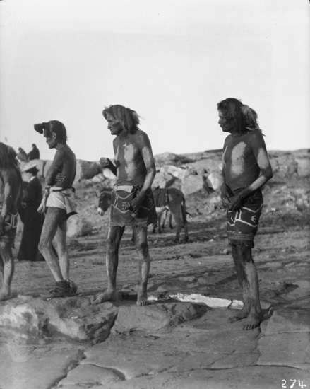 Hearst Museum object titled Black-and-white negative, accession number 15-274, described as Part of the row of Snake priests; four men, two of them are holding pouches of sacred meal.