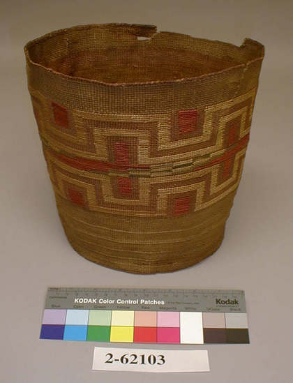 Hearst Museum object titled Basket, accession number 2-62103, described as Cylindrical, plain twined, with encircling fret design in yellow material of red boxes and right angle crosses, some blue-green accents; poor condition. Plain twined spruce root, dyed false embroidery designs in split grass stems, 5 rows of 3-strand twining near base.